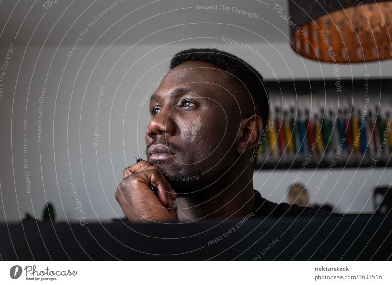 Portrait of Black Man Thinking with Hand on Chin man 1 person hand on chin African ethnicity lifestyle 20-30 years old handsome domestic life young man male