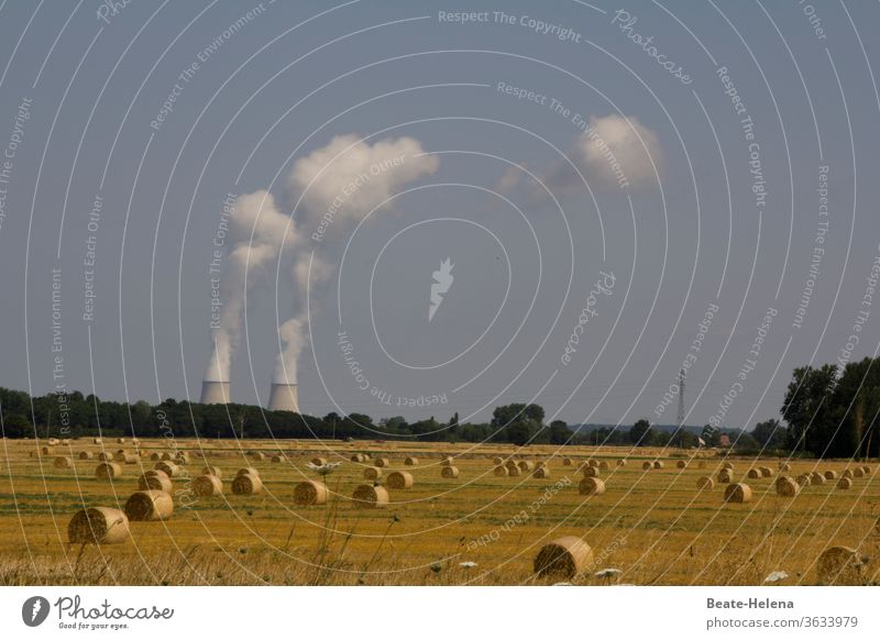 Hay bales after the harvest in front of a nuclear power plant with two cooling towers Harvest Nuclear Power Plant Energy industry Cooling tower Smoke