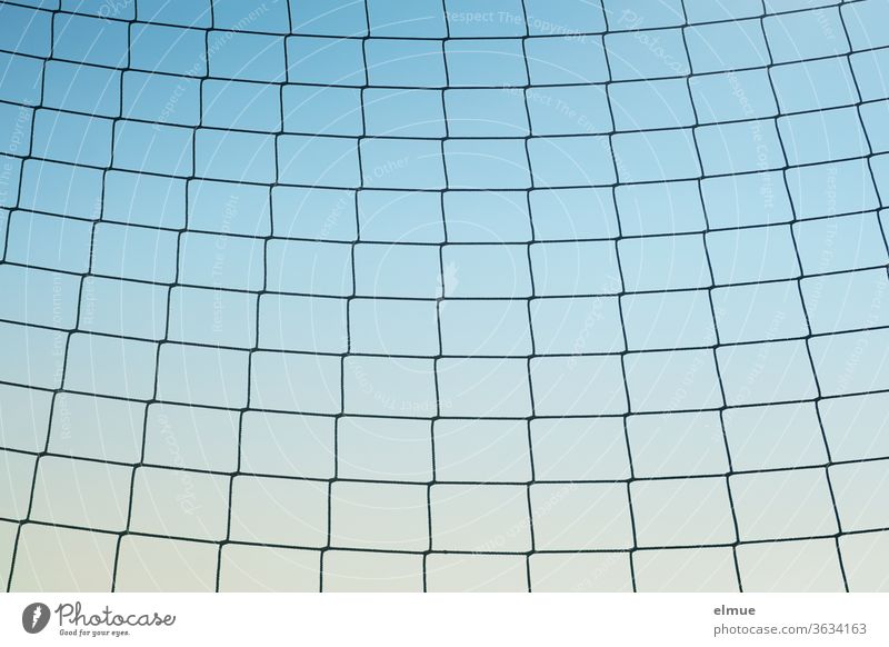 slightly sagging, coarse-meshed net at the edge of the playground against a blue background Net Ball game net Protection sidelines Playground Blue gradation