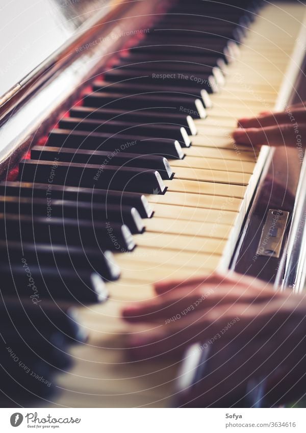 Vintage piano keys and hands playing old music child kid vintage retro traditional closeup abstract detail instrument classic learn concert