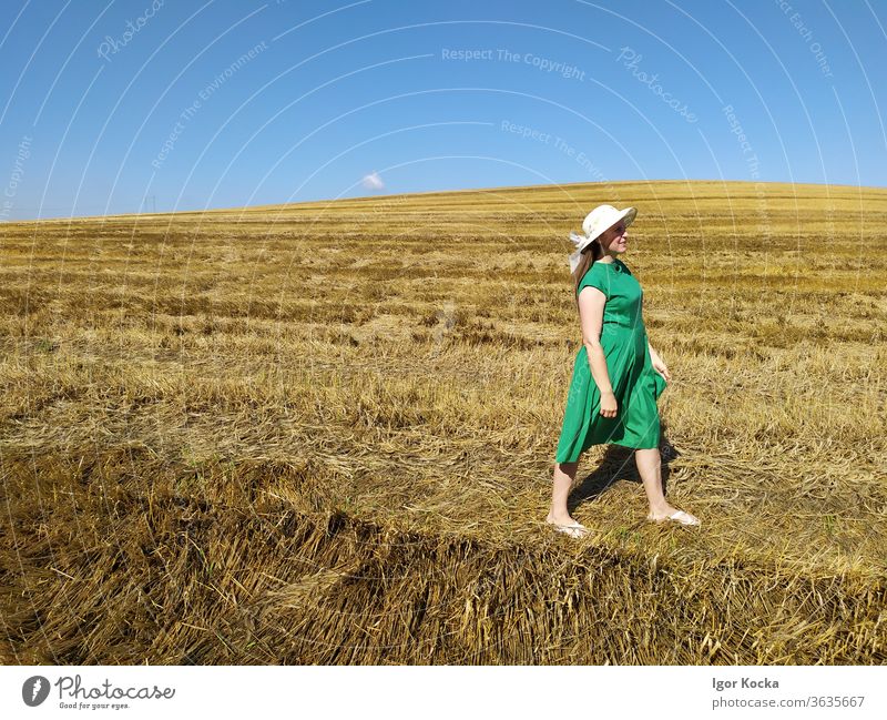 Woman Walking On Land Field Summer Clear sky Green Dress Hat Meadow Landscape Beautiful weather Freedom Lifestyle Copy Space