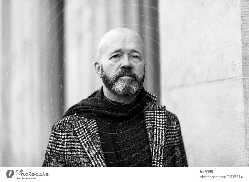 the man looks sceptically at the coming Man Facial hair Beard Coat Baldy Adults Masculine Human being portrait 1 Looking into the camera Exterior shot Face Head