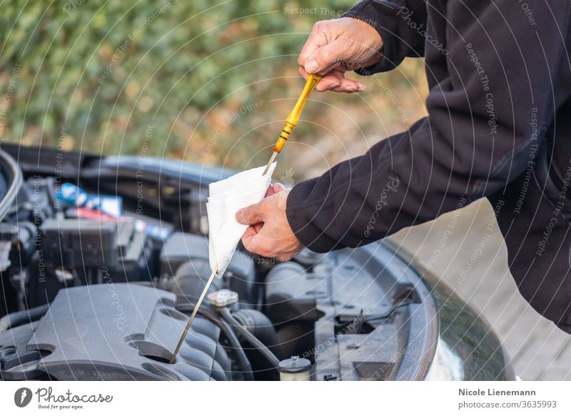 Man is checking oil level on car drive cars black petrol fuel shopping filter gas hand handy industry maintenance motor vehicle man mechanic mechanical men
