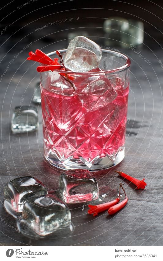 Cosmopolitan cocktail in a glass decorated with pink flowers cherry Pink bartender ice grey tools steel Alcohol Summer Refreshing Party Shiny Beverage Cool