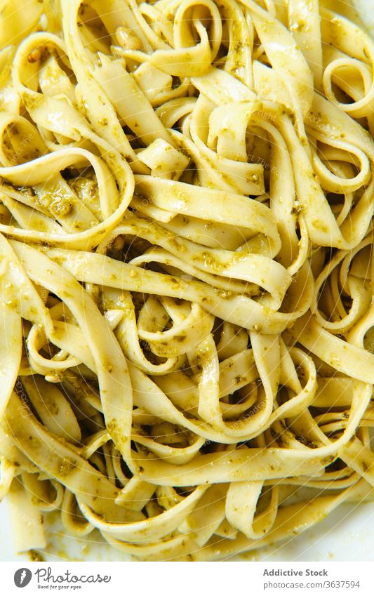 Tasty pasta with pesto salsa and fresh basil in restaurant sauce pine nut lunch tasty food dish tagliatelle dinner delicious meal cuisine gourmet italian