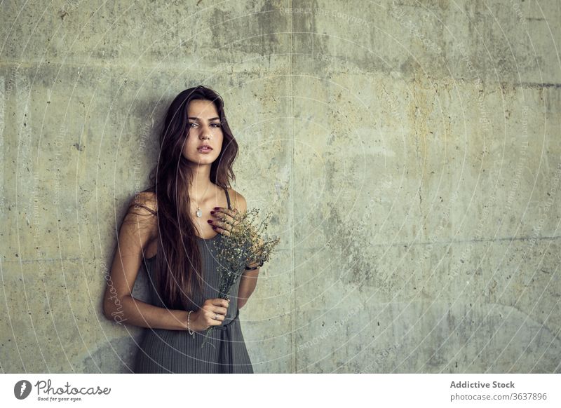 Gentle woman with wildflowers in city gentle bouquet bloom fresh serene stone wall female blossom floral elegant calm plant romantic natural bunch tranquil lady