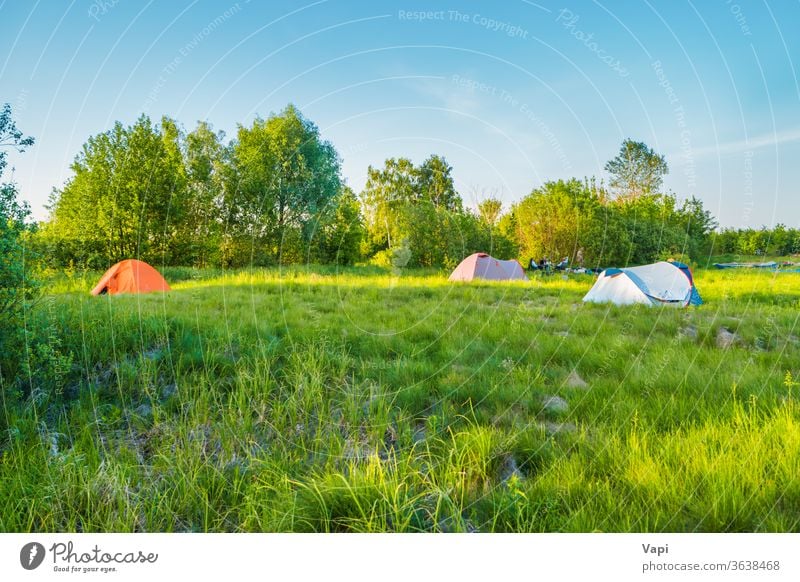 Tent camping on green grass field sunset tent forest mountain sky nature hiking adventure travel landscape tourism sunrise summer scene morning outdoor scenics