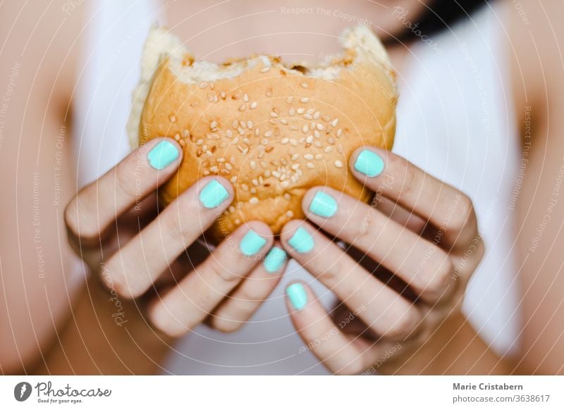 Close up of Hands Holding a Half Eaten Homemade Vegan Burger vegan burger eating dieting holding veganism close up lifestyle meal homemade hand cookery culinary