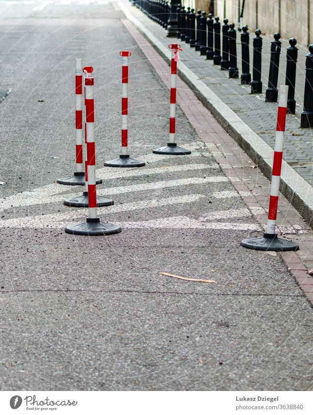 White and red traffic cones bunch risk boundary accident security caution pavement industrial pedestrians outdoors urban closeup warning street safety road