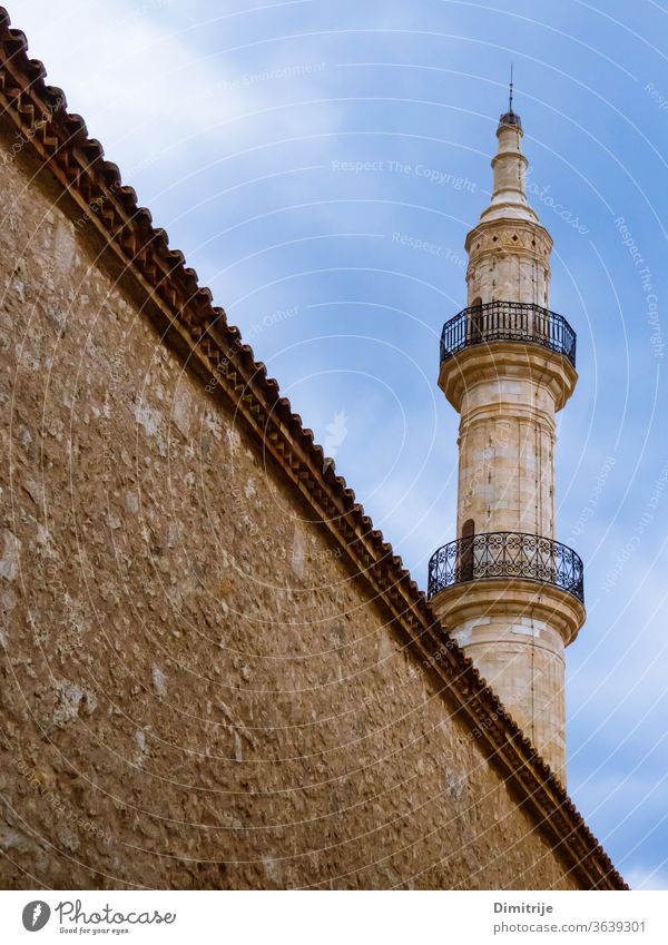 Mosque tower with big wall in front of it mosque travel tourism architecture building landmark sky town religion minaret old history city islam europe medieval