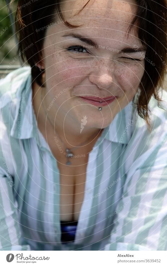 Portrait of a young, freckled woman winks and smiles Young woman Top windy hair brunette already Intensive Youth (Young adults) 18-25 years décolleté