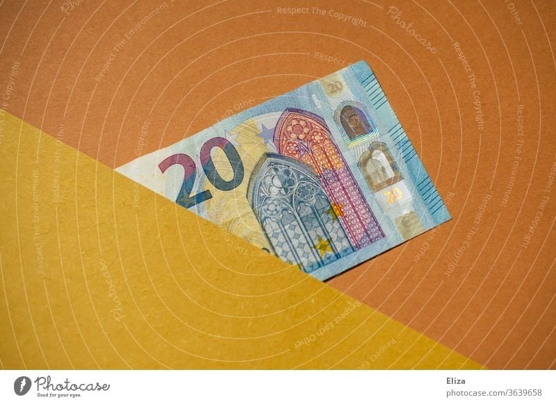 20 Euro note. Bank note. Money. 20 euros pretence half Concealed Copy Space graphically Financial Industry Save Loose change Individual Blue Yellow Orange Beige