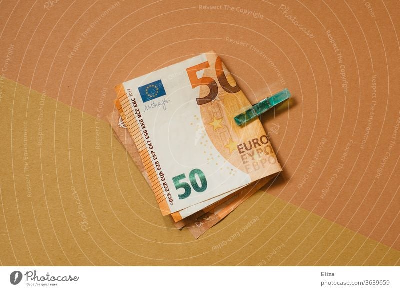 Two 50 Euro notes held by a clamp. Tone in tone. Money Notes 50s 50 euros Holder tone-in-tone Esthetic Financial Industry Bank note Save Loose change