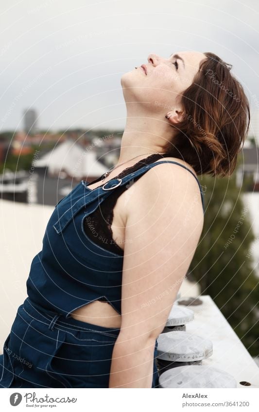 Portrait of a young, freckled woman on a roof looking up to the sky Young woman Top windy hair brunette already Intensive Youth (Young adults) 18-25 years