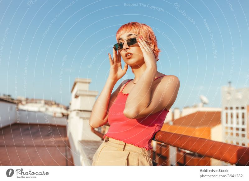 Woman standing on street woman millennial pink hair different female summer railing city lean freedom urban sunglasses delight lady eyewear happy style