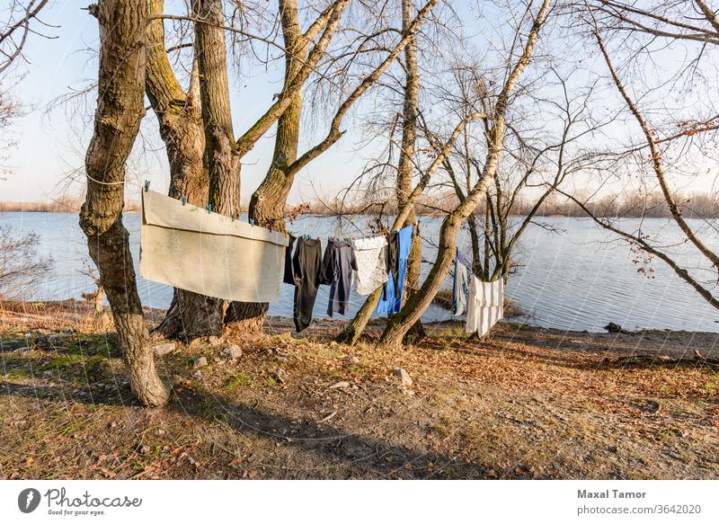 Laundry drying on a wire, under the mild winter sun, near the river Dnieper Dnieper River Kiev Kyiv Obolon Ukraine afternoon clothes clothesline clothespin
