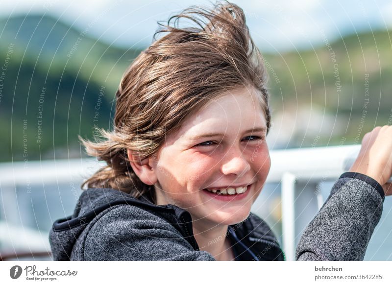 puffy | stiff breeze onm ship Exterior shot windy Contentment fortunate cheerful Happy Happiness Laughter Son Sunlight portrait Contrast Light Day Face Infancy