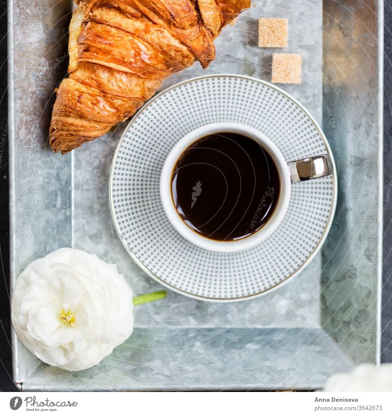 Fresh Croissant, Cup of Coffee and Ranunculus Flowers. Breakfast coffee croissant breakfast morning pastry cup white table ranunculus flowers drink tray