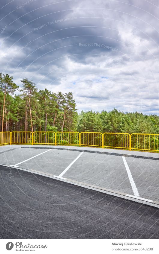 Empty highway rest area by a forest. rest stop parking nature zone transport lot road resting empty asphalt railing travel trip sky