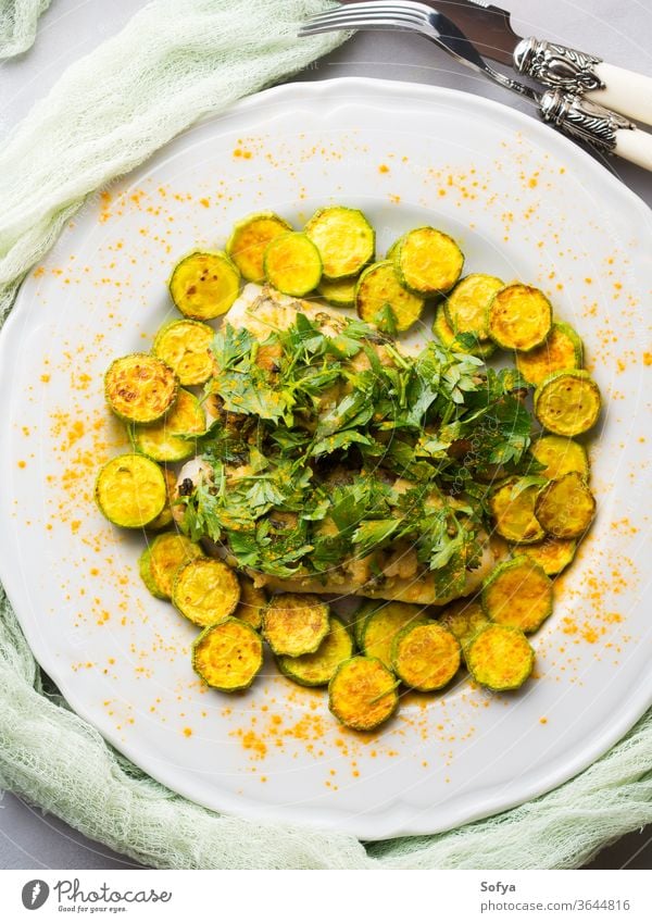 Stock fish fillet with turmeric courgettes stock baked dinner healthy lunch food gourmet seafood white zucchini cooked grill meal meat plate served spice curry
