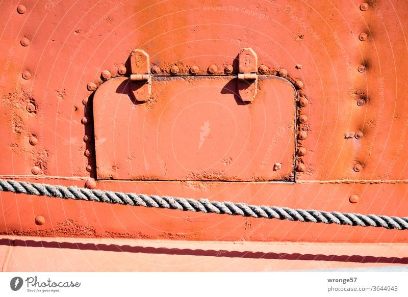 Cat flap on board | flap in the steel side of a ship boat detail Flap Ship's side Auburn Old Steel Stud hand-riveted Colour photo Exterior shot Navigation