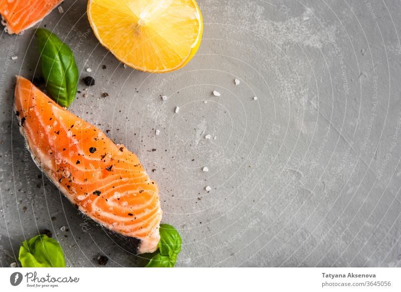 Salmon fillet piece with lemon, salt salmon fish food raw fresh healthy steak seafood cooking slice closeup pepper omega ingredient trout delicious nutrition