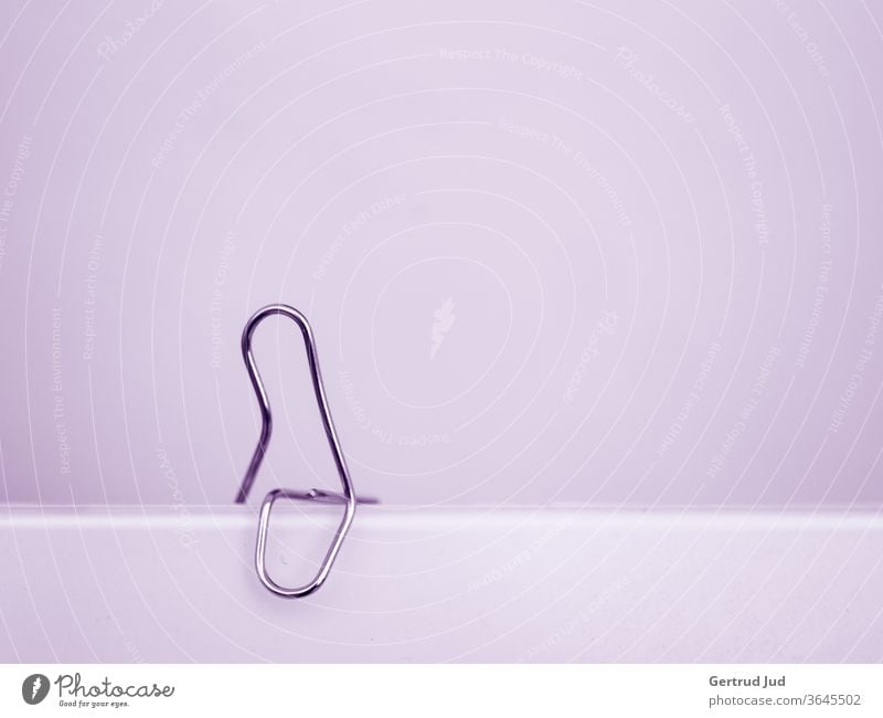 Paper clip sitting in purple room minimalism paper clip Minimalistic Blue Modern Design Abstract abstract shapes