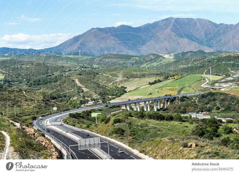 Highway passing between green mountains in daylight highway highland bridge road picturesque hill harmony nature countryside spectacular asphalt scenic hillside