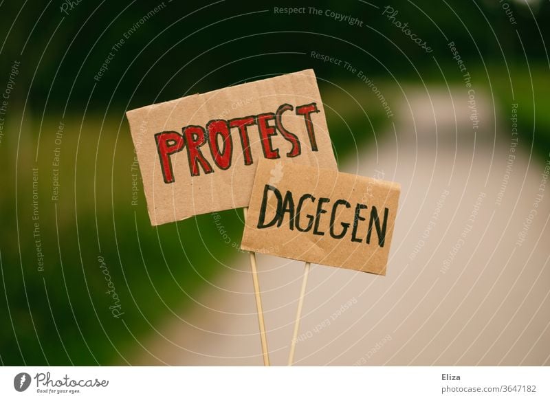 Two signs with the words PROTEST and DAGEGEN. Demonstration. protest on the other hand rejecting Protest demonstrate anti object no refusal Cancelation Opinion