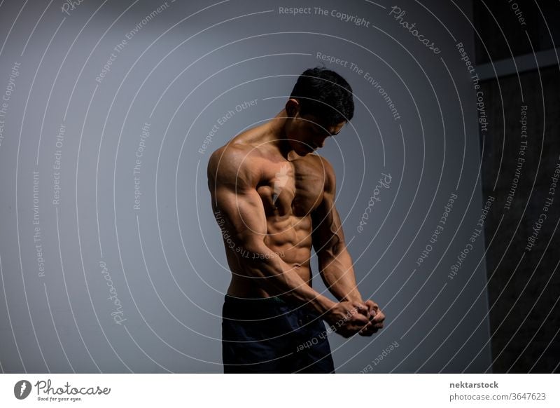 Asian Fitness Model Flexing Muscles Nam Vo fitness model male muscular muscles strength sport athletic studio shot human body physique torso shirtless posing