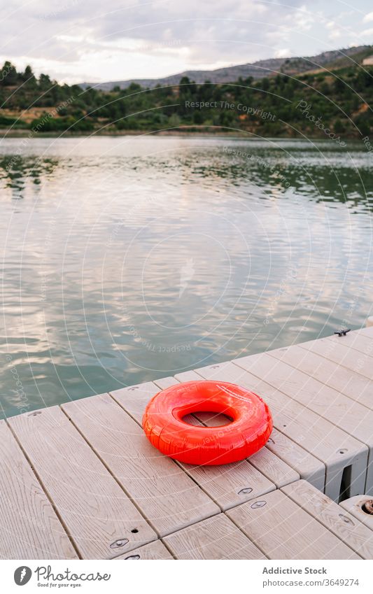 Rubber ring on pier near lake rubber inflatable pond quay majestic sunset summer water tranquil vacation holiday nature wooden dusk idyllic safe evening shore