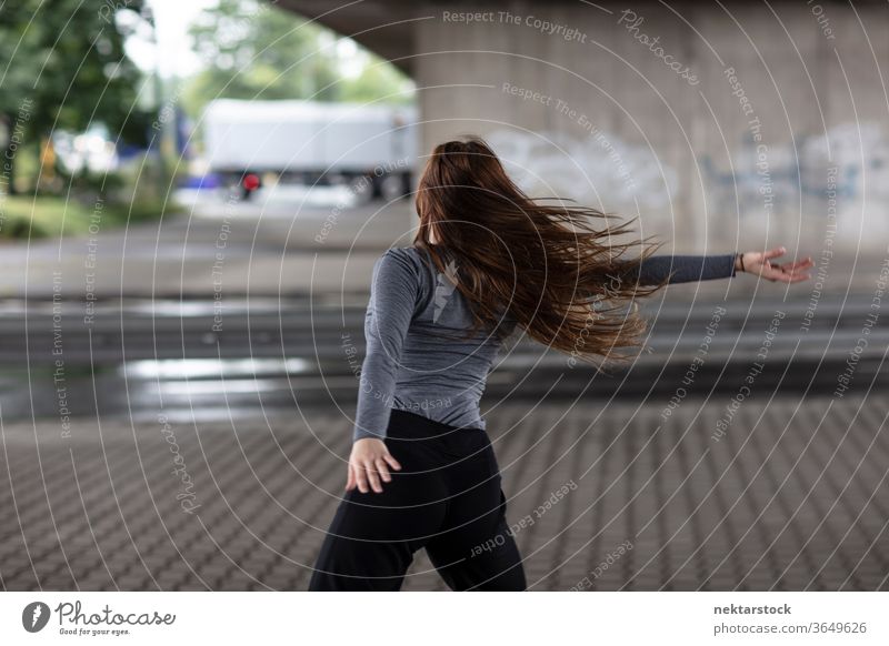 Rear View of Female Street Dancer in Motion Rear view dancer dancing motion female one person girl young woman caucasian ethnicity youth culture modern dance