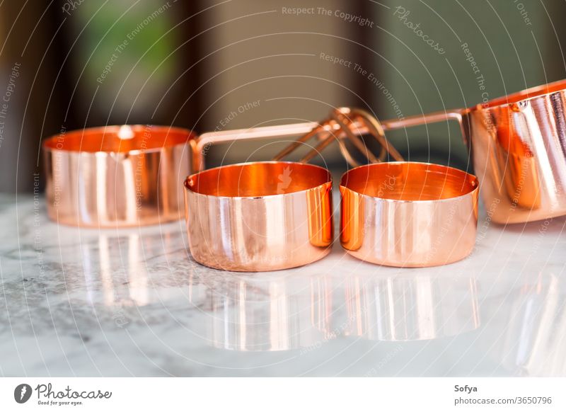 Copper cups on marble. Ready to cook measuring zero waste food kitchen meal prep bulk table copper cooking process measurement weight american unit tool utensil