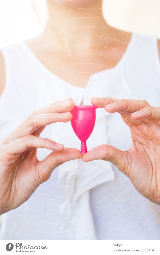 Woman holding a menstrual cup in hands zero waste woman product look menstruation pink hygiene reusable silicone alternative care clean eco female lady cup