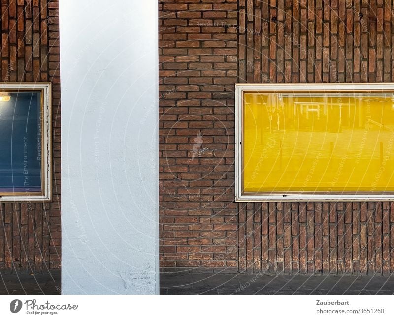Windows with yellow and blue background, brick facade and concrete pillars Facade Yellow Blue Horizontal Vertical Concrete piers Architecture Abstract
