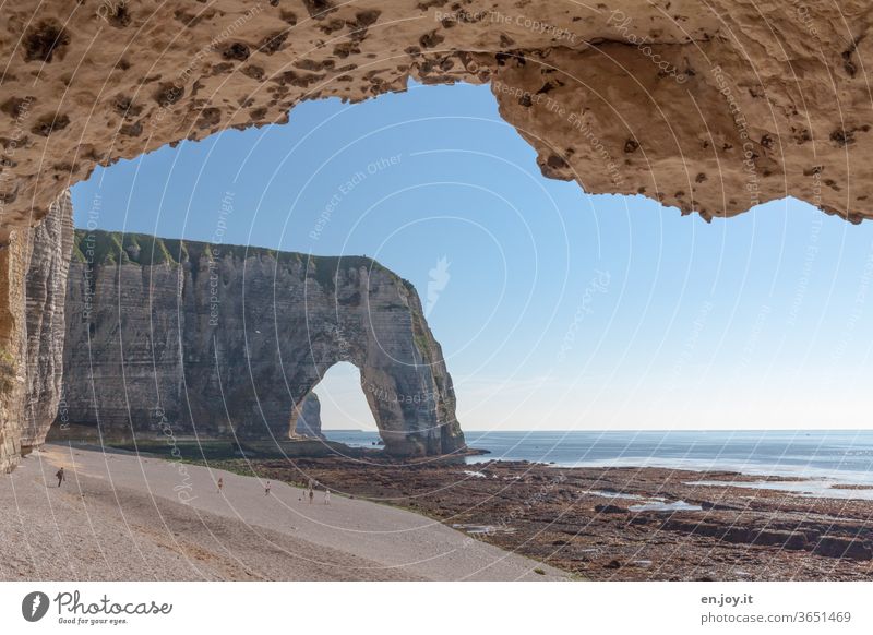 Rock arches on the beach of Étretat at low tide with a view of the sea and the horizon France Normandie Beach Ocean Low tide Horizon Limestone rock Coast cliffs