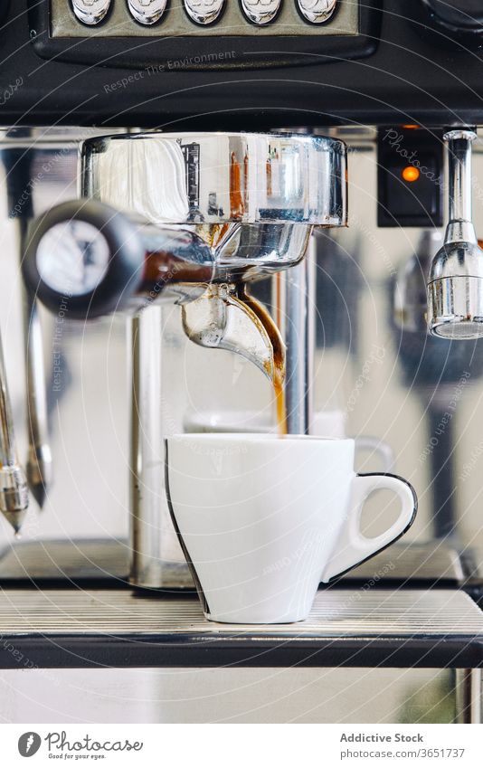 Modern coffee machine pouring coffee into white cup in restaurant modern equipment aroma process professional coffee shop fresh flavor delicious stainless steel