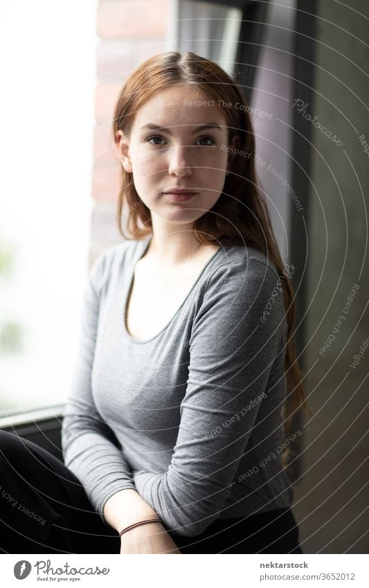 Beauty Portrait of a Young Woman Seated by Window female one person girl portrait window young woman posing indoor pose portrait pose caucasian ethnicity