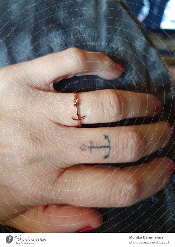 Anchor love that gets under your skin Navigation Ocean Tattoo Tattoo cover Ring by hand Woman Feminine Fingers Human being Skin Tattooed tattooing Colour photo