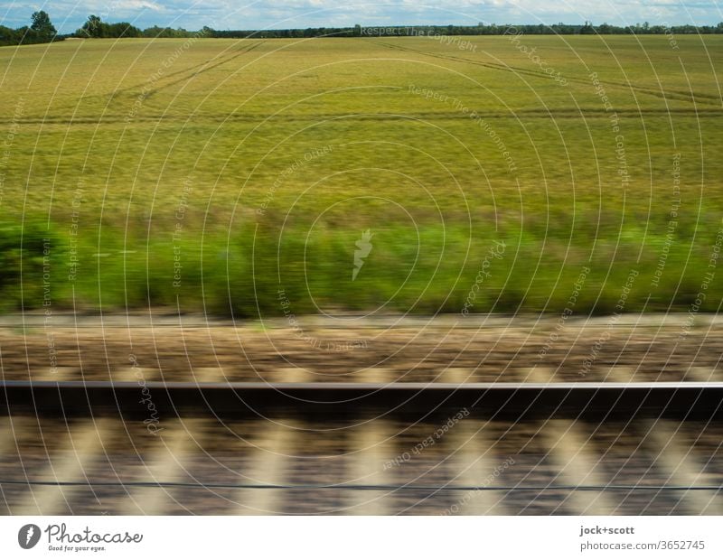 quickly we drove on rails through the summery cloudy landscape Landscape Grain field Nature Speed Panorama (View) motion blur Horizon Wanderlust naturally