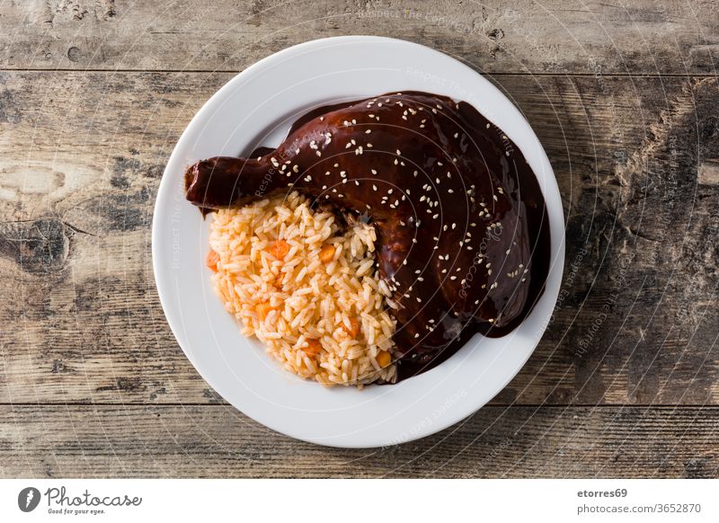 Traditional mole Poblano with rice in plate on wooden table. Top view chicken chicken mole chili chipotle chocolate cinnamon corn delicious dish food gourmet