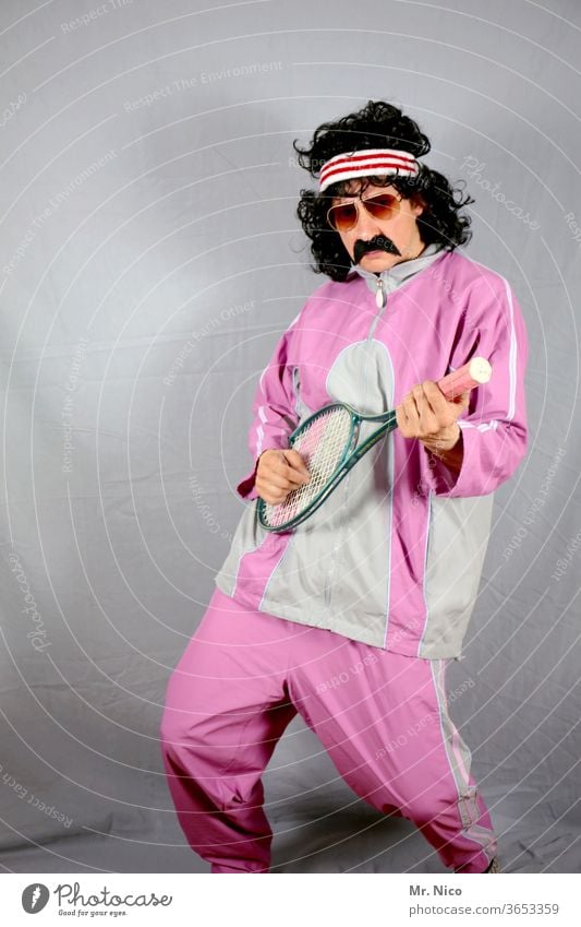 Sportsman in pink tracksuit uses tennis racket as guitar Track-suit top Pink Fashion Tennis player Tracksuit bottoms Tennis rack Curl Leisure and hobbies