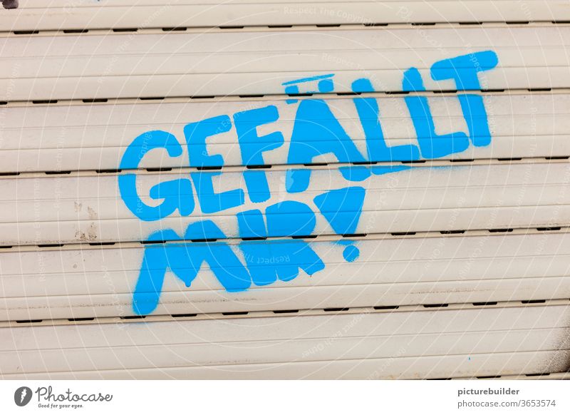 Roller shutter with message I like roller shutter Graffiti embassy Blue Beige Window Closed Exterior shot Characters Colour photo Deserted Day delighted