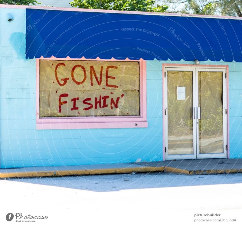 Closed shop with absence notice Gone Fishing Load Window door glued pasted up gone fishing Blue Pink broke business discontinuation Store premises built