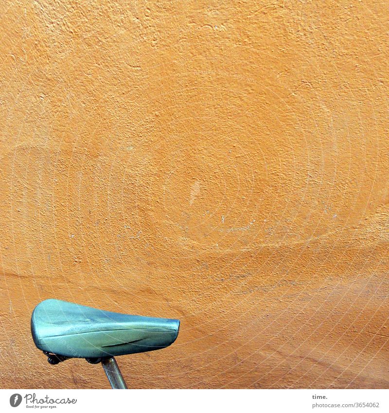 urban mobile future Bicycle saddle Wall (building) Wall (barrier) Old Trashy Plaster Orange Yellow cyan Saddle Seat shine