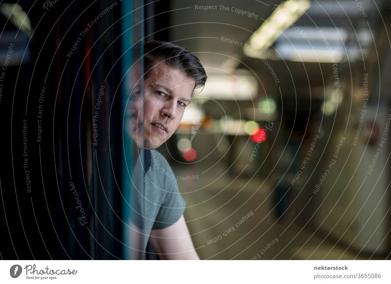 Portrait of a Man Leaning Head Out of Subway Train adult caucasian Frankfurt Germany urban handsome model selective focus rack focus headshot close up face