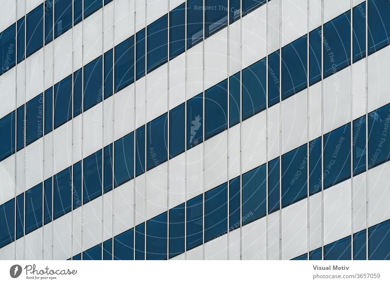 Symmetrical blue windows of an office building made of aluminum and glass facade architecture architectural architectonic urban color structure geometric