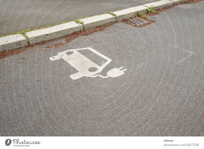 at the roadside there is a white electric car - symbol as an indication for a charging station electromobility Loading dock Eco-friendly Motoring Energy