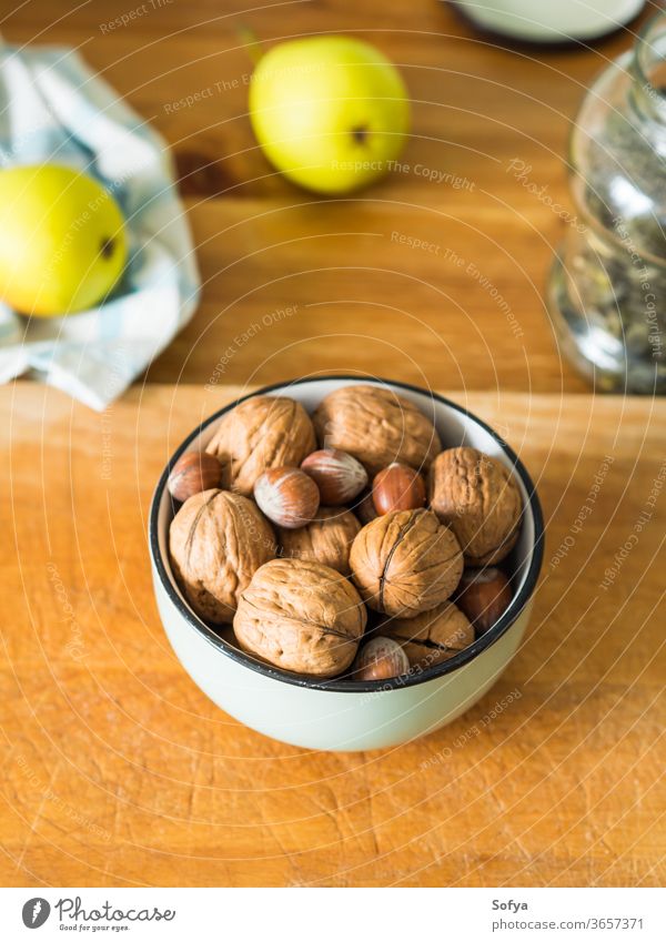 Walnuts and hazelnuts in bowl on wooden board. walnut vitamin kitchen energy protein food fruit nature tasty snack shell organic nutshell natural ingredient