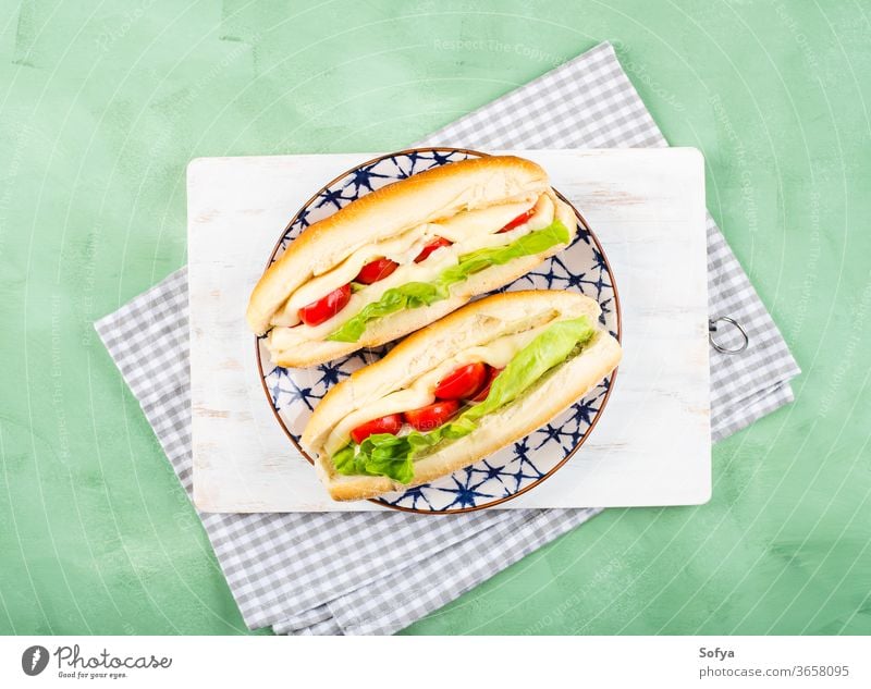 Baguette sandwich with tomatoes and cheese baguette submarine bread lunch hoagie flat lay melted vegetable top view salad lettuce wooden green fresh food white